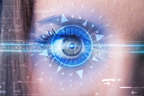 Stock photo: Cyber girl with technolgy eye looking into blue iris