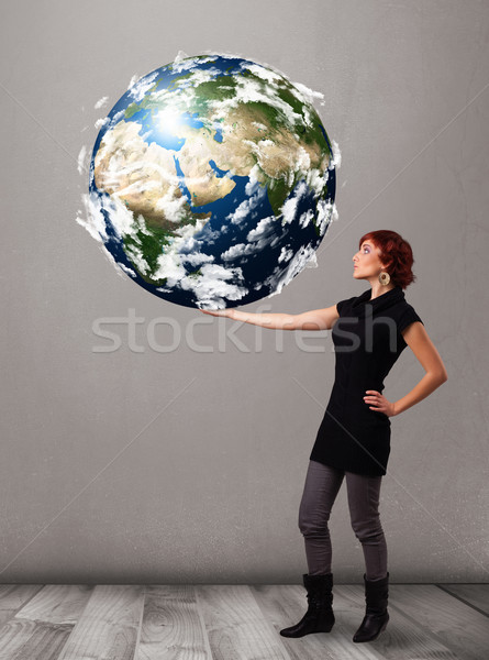 Pretty girl holding 3d planet earth Stock photo © ra2studio