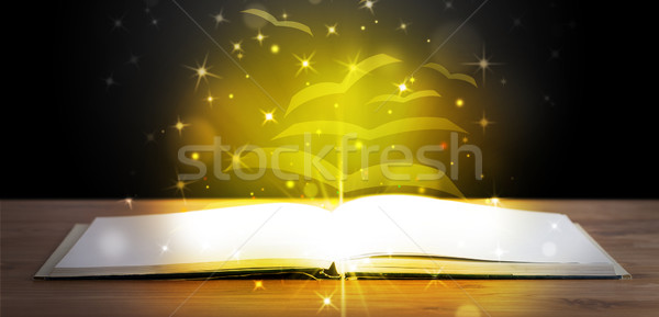 Stock photo: Open book with golden glow flying paper pages