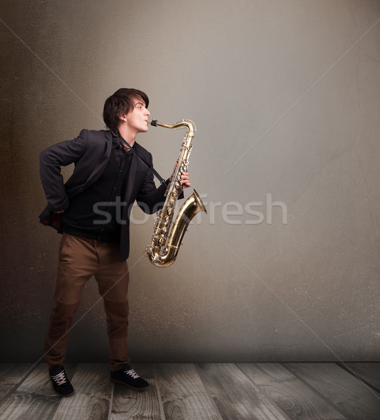 Young musician playing on saxophone Stock photo © ra2studio