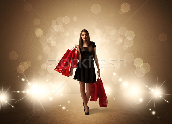 Stock photo: Shopping lady with bags in bright lights