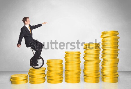 Business man riding monocycle up on coin graph Stock photo © ra2studio