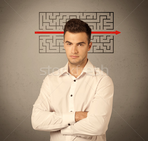 Handsome business guy solving maze Stock photo © ra2studio