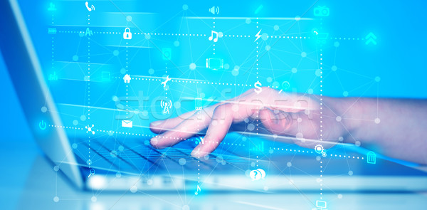 Hand pressing keyboard with high tech media icons Stock photo © ra2studio