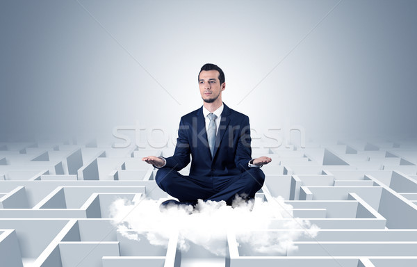 Businessman meditates on a cloud with maze concept Stock photo © ra2studio