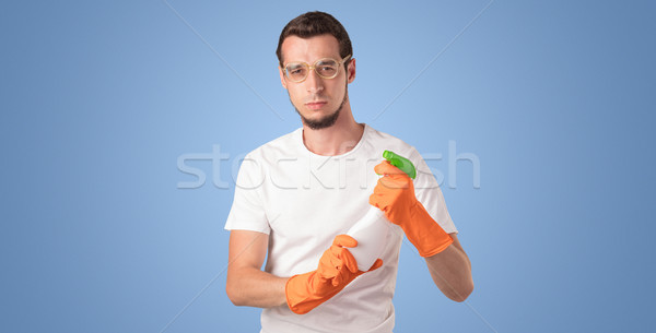 Housekeeper in front of a blue empty wall Stock photo © ra2studio