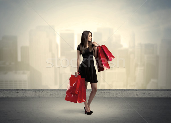 City woman standing with shopping bags Stock photo © ra2studio