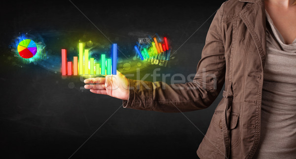 Young businesswoman touching colorful modern graph system concep Stock photo © ra2studio