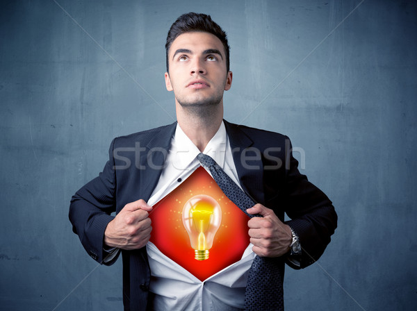 Businessman ripping off shirt and idea light bulb appears  Stock photo © ra2studio