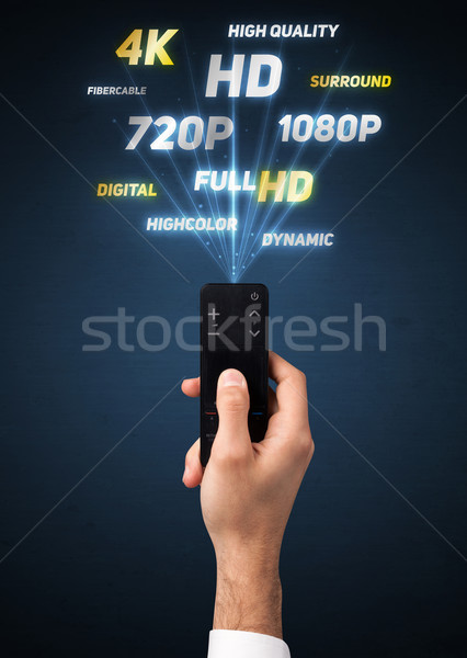 Hand with remote control and multimedia properties Stock photo © ra2studio