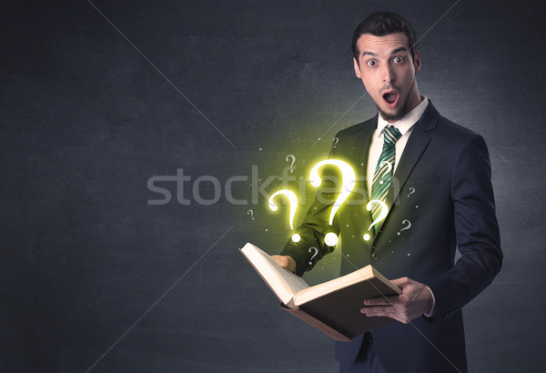 Businessman looking in a book. Stock photo © ra2studio