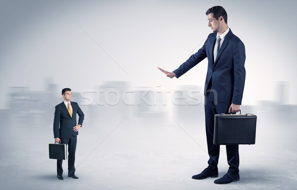 Giant businessman is  afraid of small executor Stock photo © ra2studio