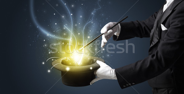 Magician hand conjure miracle from cylinder Stock photo © ra2studio