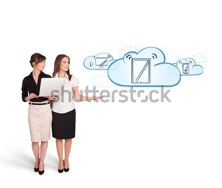 Beutiful young women presenting modern devices in clouds Stock photo © ra2studio