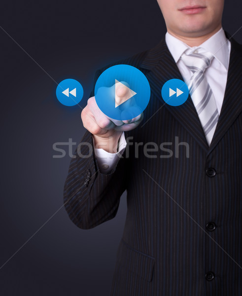 Stock photo: Man pressing media player button