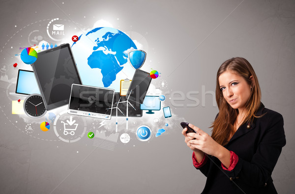 Stock photo: young woman standing and browsing on her phone