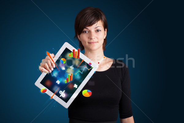 woman holding modern tablet with colorful diagrams and graphs Stock photo © ra2studio