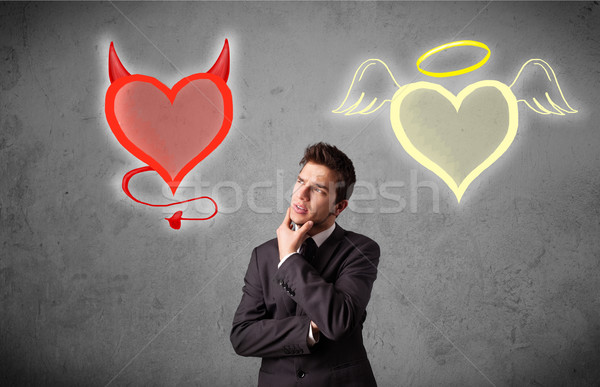 Businessman standing between angel and devil hearts Stock photo © ra2studio