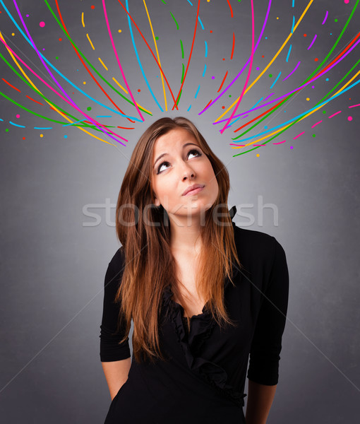 Young girl thinking with colorful abstract lines overhead Stock photo © ra2studio