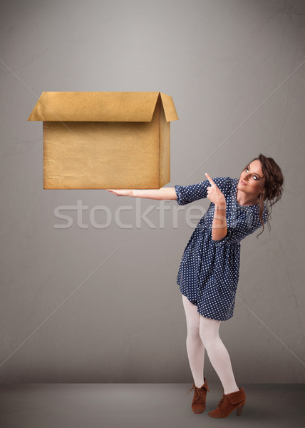 Young woman holding an empty cardboard box Stock photo © ra2studio