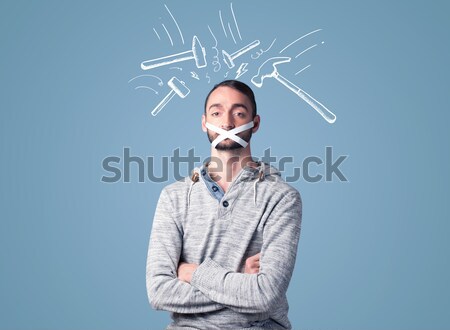 Young man with glued eye and hammer marks Stock photo © ra2studio