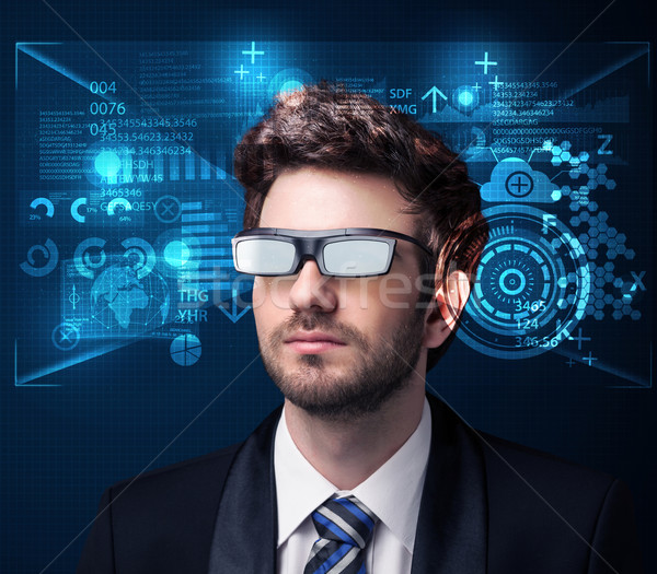 Young man looking with futuristic smart high tech glasses  Stock photo © ra2studio