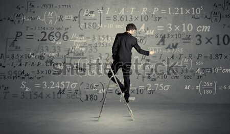 Man calculating from ladder Stock photo © ra2studio