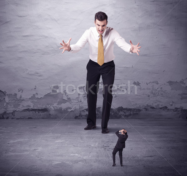 Stock photo: Angry big manager looking at small business man