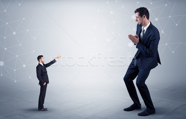 Stock photo: Small man aiming at a big man with network concept