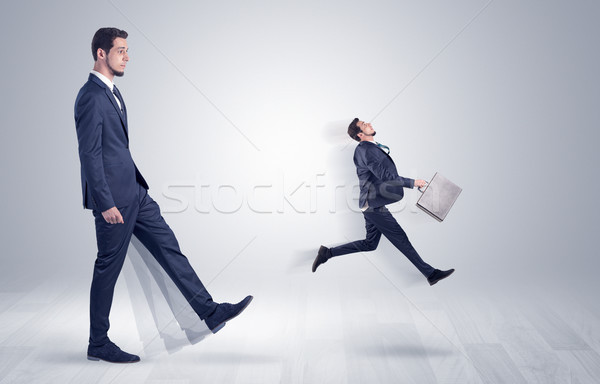 Giant businessman kicking out little businessman  Stock photo © ra2studio