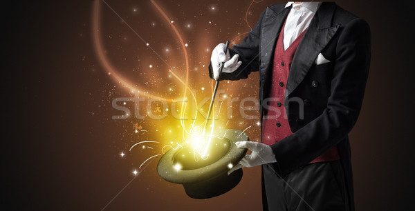 Magician hand conjure miracle from cylinder Stock photo © ra2studio