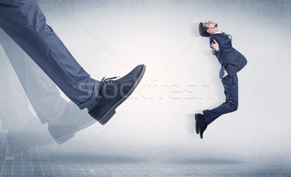 Businessman foot kicking small businessman Stock photo © ra2studio