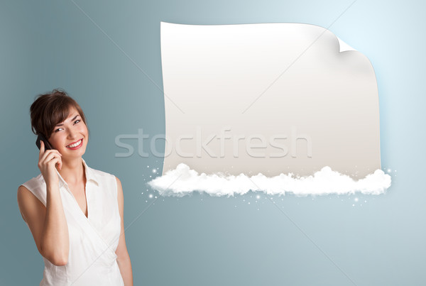 Stock photo: pretty young woman making phone call and presenting modern copy space on clouds