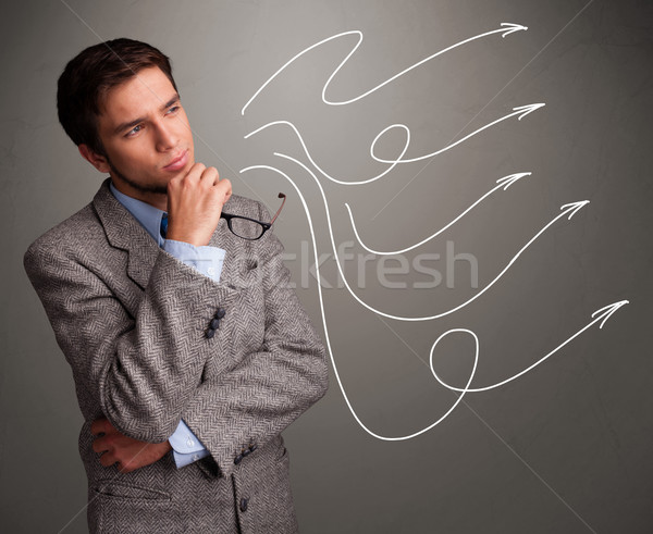 Attractive man looking at multiple curly arrows Stock photo © ra2studio