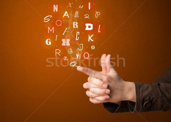 Letters coming out of gun shaped hands Stock photo © ra2studio