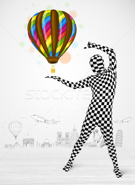 Stock photo:  man in full body suit holding balloon