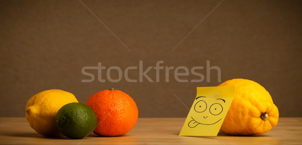 Lemon with post-it note sticking out tongue to citrus fruits Stock photo © ra2studio
