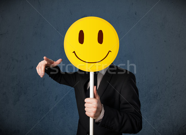 üzletember tart mosolygós arc emotikon citromsárga fej Stock fotó © ra2studio