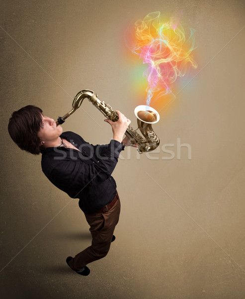 Attractive musician playing on saxophone with colorful abstract  Stock photo © ra2studio