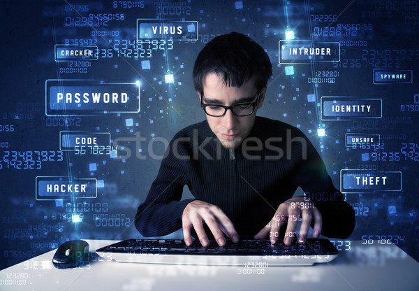 Stock photo: Hacker programing in technology enviroment with cyber icons 