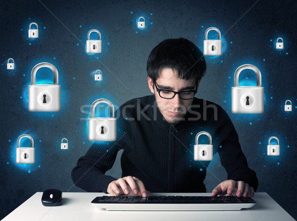 Young hacker with virtual lock symbols and icons Stock photo © ra2studio