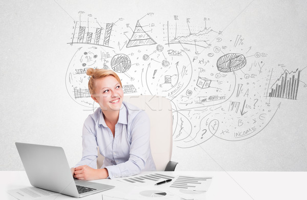 Business woman at desk with hand drawn charts  Stock photo © ra2studio