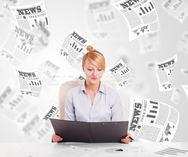 Business woman at desk with stock market newspapers Stock photo © ra2studio