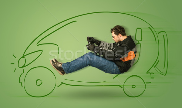 Stock photo: Man drives an eco friendy electric hand drawn car 