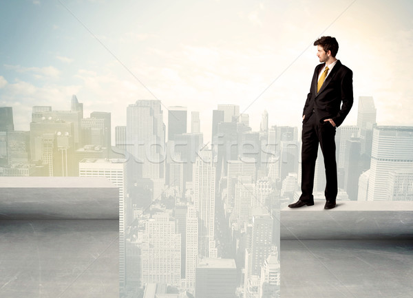 Businessman standing on the edge of rooftop Stock photo © ra2studio