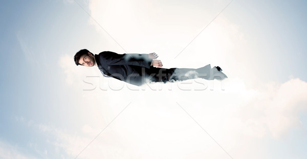 Business man flying like a superhero in clouds on the sky Stock photo © ra2studio