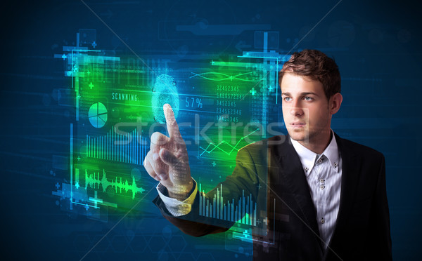 Young businessman pressing modern technology panel with finger p Stock photo © ra2studio