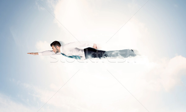деловой человек Flying подобно superhero облака небе Сток-фото © ra2studio