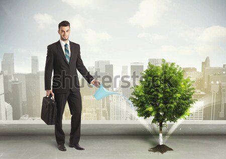 Stock foto: Geschäftsmann · Bewässerung · Stadt · Blume · Geld