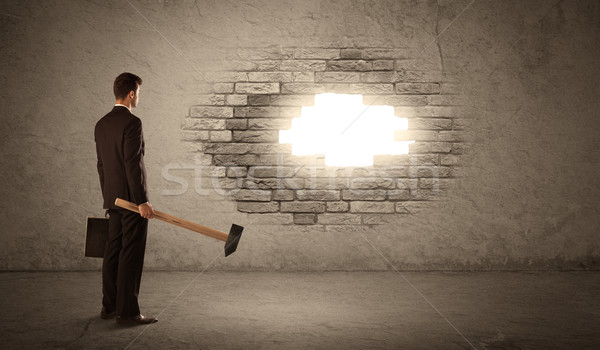Homme d'affaires mur de briques marteau ouverture trou brique [[stock_photo]] © ra2studio